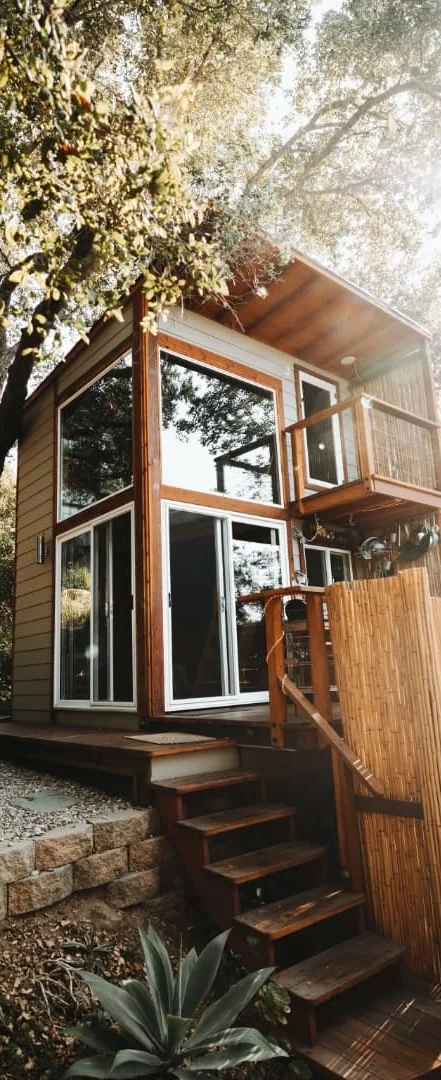 Modern tiny house with wooden exterior and large windows